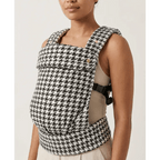 Woman wearing black and white houndstooth patterned baby carrier