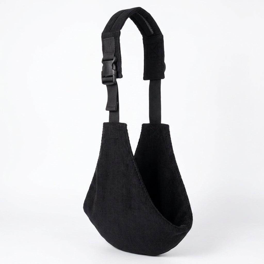 Black corduroy baby carrier sling with adjustable strap on white background