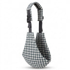 Houndstooth patterned baby carrier sling with adjustable shoulder strap on white background