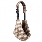 Brown and white houndstooth baby carrier sling with adjustable strap on white background