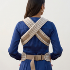 Close-up of the Tiny Table Houndstooth baby carrier's padded straps and buckles