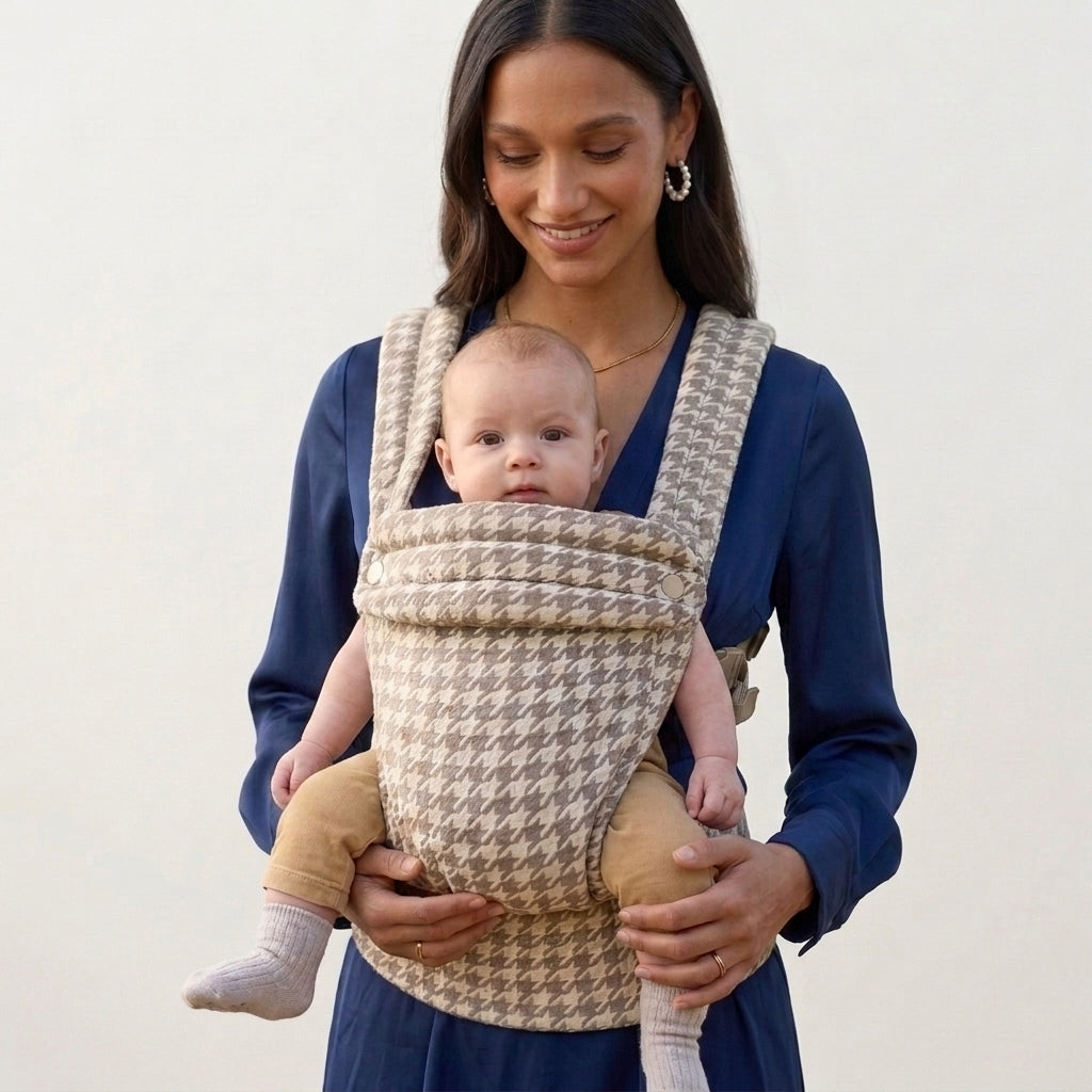 Parent wearing the Tiny Table Houndstooth ergonomic baby carrier outdoors
